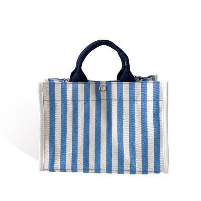 China Normcore/2021 factory direct minimalist high quality striped handbag fashion shopping bag canvas single splicing bag for sale