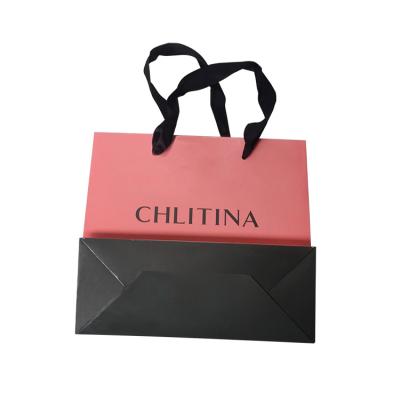 China Custom Recycled Materials HXC Logo Design Ribbon Handle Gift Pink Shopping Paper Bags for Clothing Apparel for sale