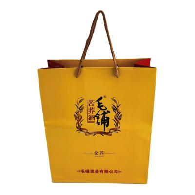 China Recyclable Durable Customized Yellow Wine Paper Bags Packaging With Your Own Logo for sale