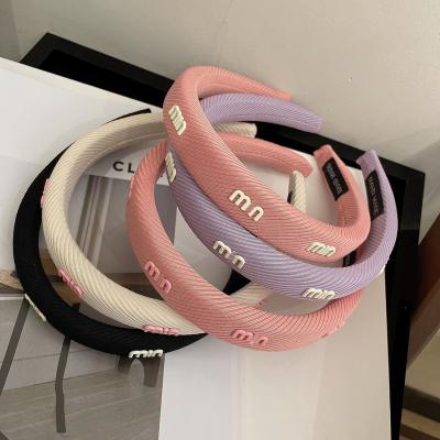 China Korean Summer Non-slip Female Fresh Skull Headband Multi-letter Version Solid Color Sponge Headband Top Headdress for sale