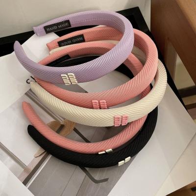 China New Macaron Candy Color Stripe Fabric Soft Letter Headband Non-slip Sense Diagonal Premium Headband for sale