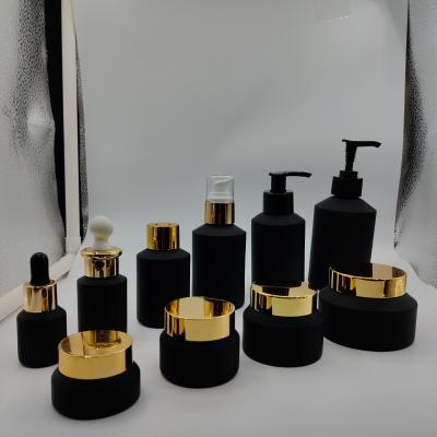 China New Cosmetic Packaging Black Set Essential Oil Dropper Bottles Glass Cosmetic Bottle With Pump for sale