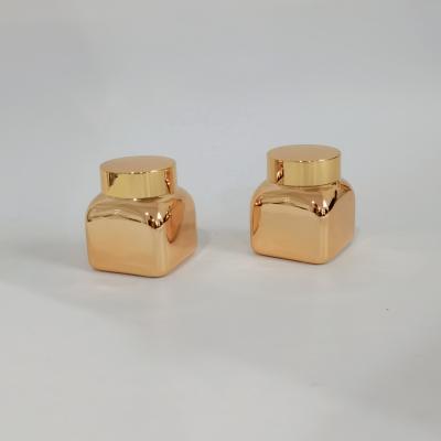 China 50g Square Cosmetic Gold Jars Series 50g Square Gold Glass Cream Jar With Gold Cap Products for sale