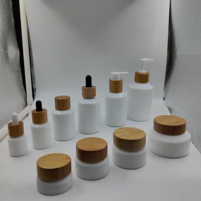 China Hot Sale Fashionable Stock Factory Packaging 15g 30g 50g 100g Opal White Glass Jar With Bamboo/Cosmetic White/Gold/Black Lid for sale