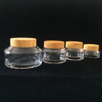 China 15ml30ml50ml 100ml cosmetic clear cream glass jars with bamboo design plastic lid for sale