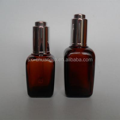 China Cosmetic Packaging Square 30ml 50ml Essential Oil Glass Amber Bottle With Silver Pump Dropper for sale