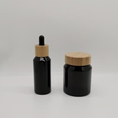 China 50ml Shoulder Series 50ml Glass Bottle 120g Shoulder Slant Black Cosmetic Slant And Bamboo Shoulder Glass Dropper/Lid for sale