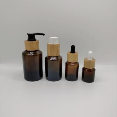 China Cosmetic cosmetic glass bottle set cosmetic amber oblique shoulder glass bottle with dropper/pump set bamboo products for sale