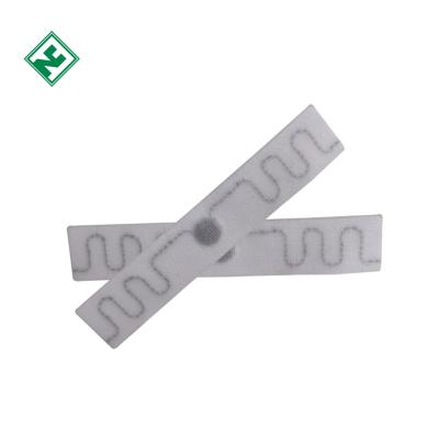 China Washable Fabric Label RFID Waterproof Uhf Laundry Tag 70*15mm Readable Waterproof for sale