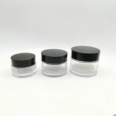 China New Design 20g 30g 50g Personal Care Clear Glass Cream Jar With Black Plastic Cap for sale