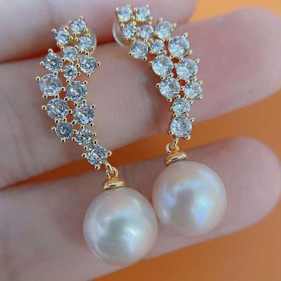 China TRENDY Full Diamond Inlaid 14K Gold Filled 925 Sterling Silver Stud Earrings 10-11 mm Almost Round Half Hole Freshwater Pearl Earrings for sale