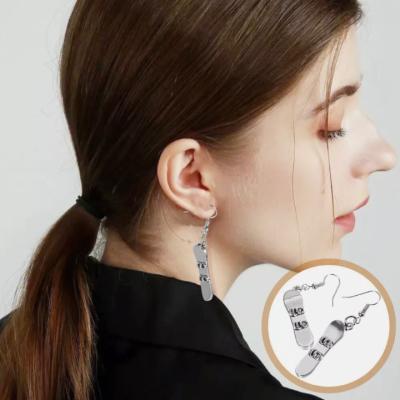 China Fashion Creative Sports Style Cast Ski Sleigh Pendant Stainless Steel Earrings Custom Medical Steel Personality  Fashion Sports Earrings for sale