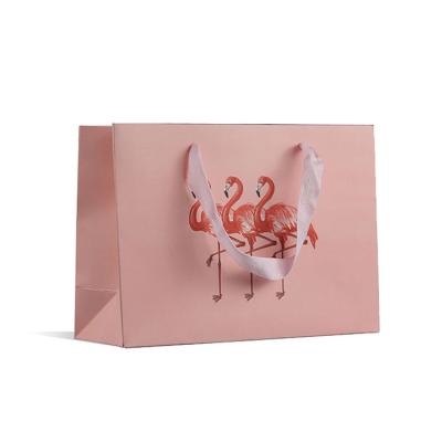 China Recyclable custom luxury clothing retail bag packing bolsas de papel pink shopping bag gift packaging paper bags with handles for clothes for sale