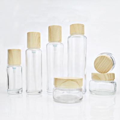 China Custom Empty Clear Cosmetic Glass Bottle Set E - Friendly Face Cream Glas Jar Packaging for sale