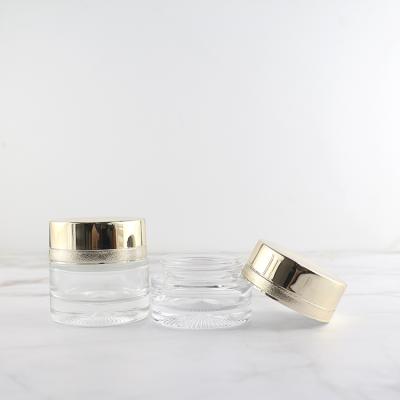 China 25G 35G Luxury Clear Round Airtight Skin Care Jar Face Cream Glass Jar With Gold Lid for sale