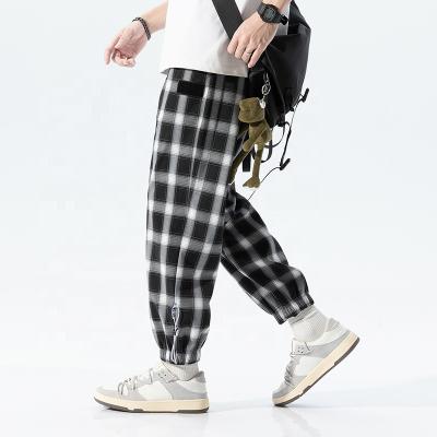 China fashion loose men's street wear pants Anti-wrinkle stock plaid pants OEM private labels stretch drawstring track casual pants for sale