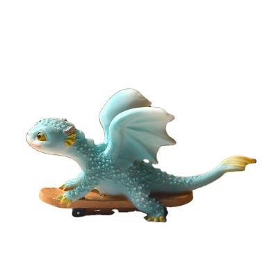 China Z13753A Creative Europe Gift Ornaments Naughty Cartoon Color Blue Dragon Skateboarding Resin Figurine Desktop Decor for sale