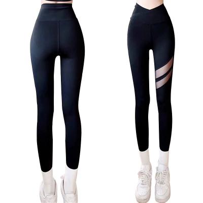 China Bestselling Breathable Women High Waist Sports Yoga Pants Black Cross Waist Hollow Shark Pants For Sports for sale