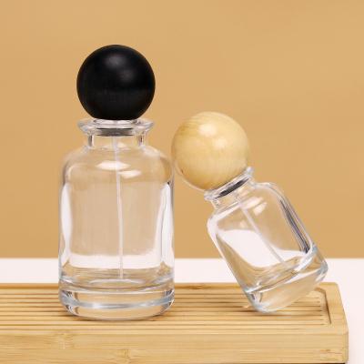 China Custom Unique round 30ml 50ml 100ml Clear Luxury Empty Glass Spray Perfume Bottles Packaging Glass Bottle With Ball Cap for sale