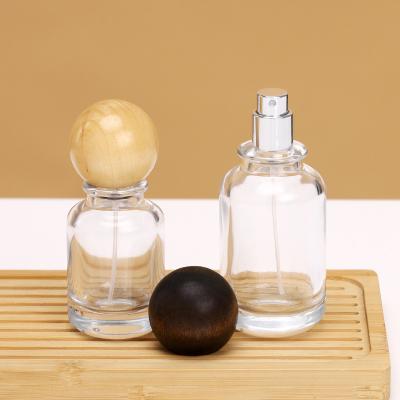 China Glass spray perfume bottles creative 30ml 50ml 100ml round clear transparent Crimp pump spray perfume glass bottle for sale