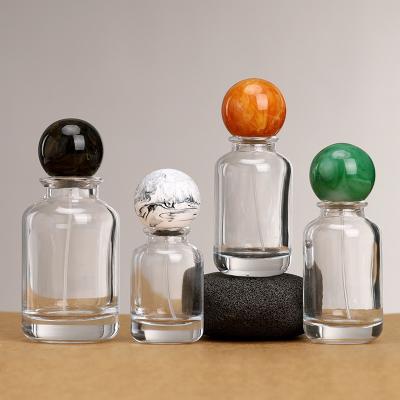 China Wholesale  Round 30ml 50ml 100ml Clear Perfume Glass Bottle Empty Cosmetic Perfume Packing Glass Bottle With Ball Cap   for sale