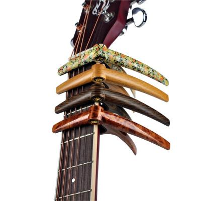 China Acoustic Electric Guitar /Ukulele Guitar Parts and Accessories High Grade Wood Grain Spring Clamp Adjustable Capo Guitar Accessories for sale