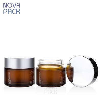 China 100g Cosmetic Cosmetic Containers Wide Mouth Frosted Amber Glass Scrub Jar Face Cream Lotion Jars 100ml Body Butter Jars With Silver Lid for sale