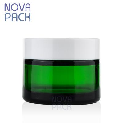 China Wholesale Cosmetic Packaging Jar Green Glass Moisturizer Cream Jar Colored Round Glass Cosmetic Cream Jars Jars With White Lids for sale