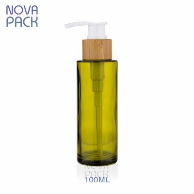 China 100ml Green Glass Bottbe Eco-Friendly Olive Bamboo Pump Face Cream Bamboo Pump Packaging Bottles Body Lotion Bamboo Cosmetic Bottles Green for sale