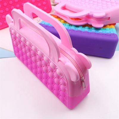 China 2022 Reusable The Latest Silicone Push Pop Cosmetic Bags Women Shape Handbags Wiggle Toys Bags For Adults for sale