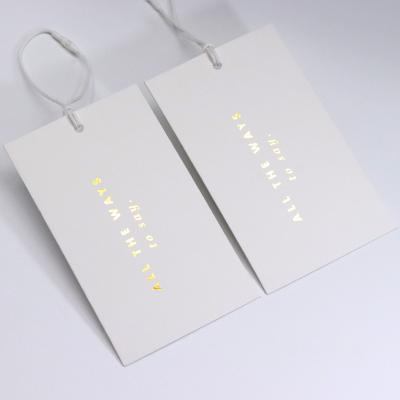 China Viable Customized Wholesale Coated Paper Label Fabric Tag Gold Foil Print Coated Paper Tag For Garment for sale