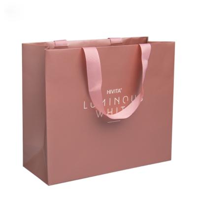 China Plain Recyclable Rose Gold Foil Luxury Paper Custom Bag With Silk Ribbon Handles for sale