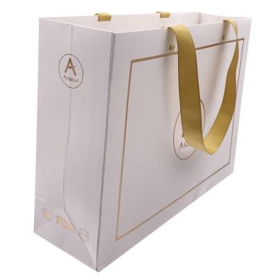 China Handmade Luxury Custom Printed Hot Foil Laminated Paper Gift Packaging Bag With Logo For Clothing Paper Shopping Box for sale