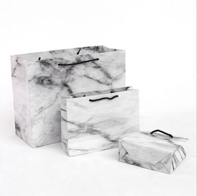 China Luxury Recycled Materials Texture Marble Paper Suits Mailing Bag Clothing Packaging Gift Bag With Handles for sale