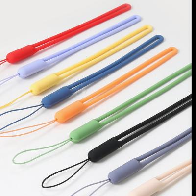 China Phone Sling Buckle Cell Phone Solid Color Soft Silicone Wrist Strap Rubber Lanyard for sale