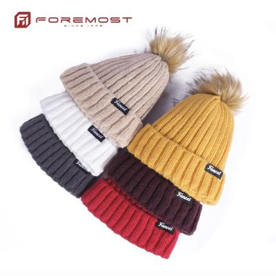 China JOINT Custom Label Beanie Hats Knitted Pompom Beanie Winter Hat Woven Beanies For Women for sale