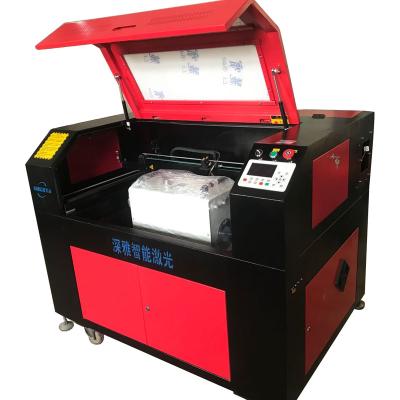 China Laser CUTTING easy installation jeans pants plastic laser engraving cutting machine 6090 stamp nipple laser engraving machine for sale