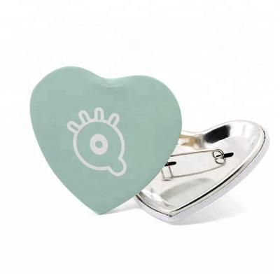 China Custom Europe Logo Heart Shaped Buttons Pin Back Badge for sale