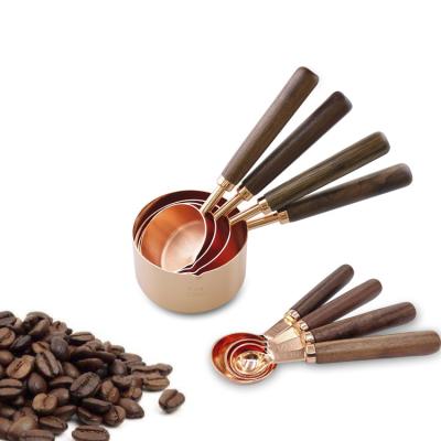 China Sustainable Rose Gold 4 PCS Set Walnut Handle Food Grade Stainless Steel Wooden Measuring Cup Measurer Set for sale