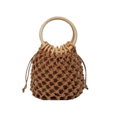 China Fashion the latest 2021 summer straw basket bag weaving bucket hollow drawstring mesh tote bag popular Korean for sale