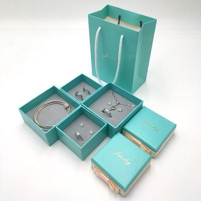 China Ornament Packaging Box Custom Foil Print Logo Gift Packaging Blue Bowknot Box Display Ring Necklace Jewelry Box for sale