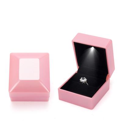 China Ornament Packaging Box Wholesale Outside Plastic Inside Velvet Proposal Ring Display LED Light Jewelry Box for sale