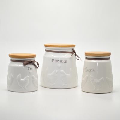 China Sustainable White Ceramic Kitchen Cookie Sugar Tea Food Canister Storage Jar And Bottles Set With Wooden Lids for sale