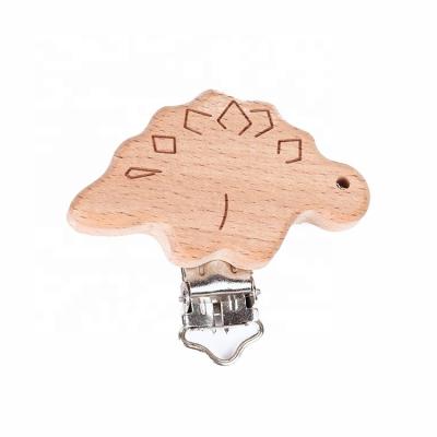 China Custom Diy Logo Beech Wood Animal Engraved Wholesale Stegosaurus Shape Teething Clip Baby Pacifier Clip BPA Free Wholesale for sale