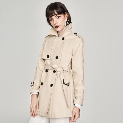 China Anti-wrinkle factory stock cream color mid length cross trench coat for women with raglan sleeve for sale