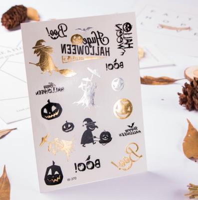 China Glow In The Dark Gold Stamping Glow In The Dark Halloween Pumpkin Skull Pattern Temporary Tattoo Sticker for sale