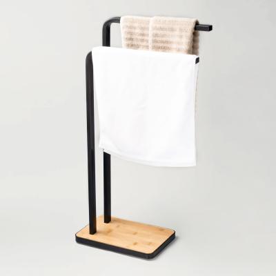 China New Black Bath Towel Stand Tower Holder With Two Arms Hand Free Standing Bathroom Wooden Bamboo Towel Rack for sale