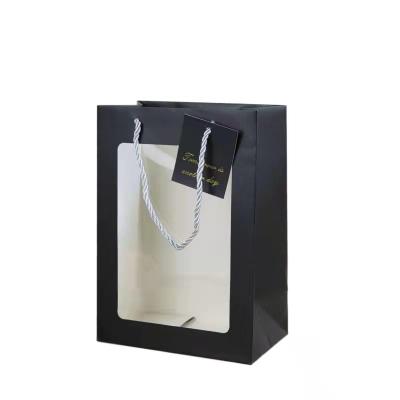 China Recycled Materials Wholesale Custom Logo Paper Gift Bag Black Paper Flower Bag Flower Packaging Paper Bags With White Rope Handle for sale