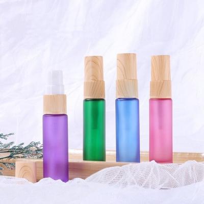 China Cosmetic LOW MOQ Frost Colored 10ml Roll On Glass Bottle With Wood Grain Pump for sale