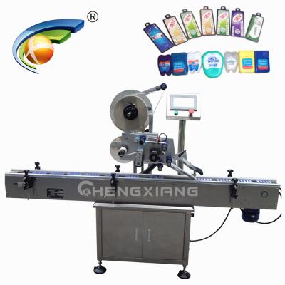 China automatic beverage paging and labeling machine for card box box, top labeling machine factory for sale